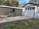 View of manufactured home and garage from driveway at 10040 Jungle St, New Port Richey, FL 34654