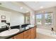Spacious bathroom with double sinks, a bathtub and large mirror at 102 S Moody Ave # 3, Tampa, FL 33609