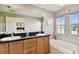 Elegant bathroom with double sinks, soaking tub, and large mirror at 102 S Moody Ave # 3, Tampa, FL 33609