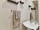 Small half bath with pedestal sink and neutral decor at 102 S Moody Ave # 3, Tampa, FL 33609