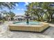 Outdoor fountain and seating surrounded by trees in an urban shopping environment at 102 S Moody Ave # 3, Tampa, FL 33609
