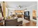 Open living room with hardwood floors, a sectional sofa, and a view of the kitchen at 102 S Moody Ave # 3, Tampa, FL 33609