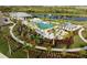 This aerial view showcases the community pool and lounge area, surrounded by lush landscaping at 12241 Meditation Trl, Venice, FL 34293