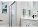 Modern bathroom with frameless shower and dual vanity at 12241 Meditation Trl, Venice, FL 34293