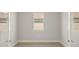 Bright bedroom with modern wood-look tile flooring and a window providing natural light at 12241 Meditation Trl, Venice, FL 34293