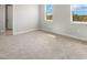Bright, spacious bedroom with neutral carpeting, two windows, and ample natural light at 12241 Meditation Trl, Venice, FL 34293