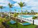 This community pool area offers lounge seating, hammocks, and beautiful landscaping at 12241 Meditation Trl, Venice, FL 34293