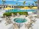 Community hot tub surrounded by Adirondack chairs, perfect for relaxing by the pool at 12241 Meditation Trl, Venice, FL 34293