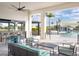 Covered outdoor bar area overlooking the swimming pool, with comfortable seating and stylish design at 12241 Meditation Trl, Venice, FL 34293