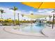 Resort-style swimming pool with lounge chairs, umbrellas, and a covered seating area at 12241 Meditation Trl, Venice, FL 34293