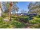 Landscaped backyard with lush greenery and canal views at 1688 Watermark Ne Cir # 1688, St Petersburg, FL 33702