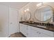 Modern bathroom with double vanity, granite countertops, and large mirrors at 1688 Watermark Ne Cir # 1688, St Petersburg, FL 33702