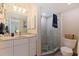 Modern bathroom with granite countertops, a glass-enclosed shower, and contemporary fixtures at 1688 Watermark Ne Cir # 1688, St Petersburg, FL 33702
