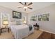 Cozy bedroom featuring a queen-size bed, soft lighting, and views to outside greenery for a relaxing ambiance at 1688 Watermark Ne Cir # 1688, St Petersburg, FL 33702