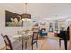 Bright dining and living space with modern light fixture, fireplace, and access to an outdoor patio at 1688 Watermark Ne Cir # 1688, St Petersburg, FL 33702