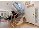 Bright entryway with staircase, piano, and hardwood floors at 1688 Watermark Ne Cir # 1688, St Petersburg, FL 33702