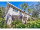 Condo building exterior with screened patio and lush landscaping at 1688 Watermark Ne Cir # 1688, St Petersburg, FL 33702