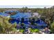 Beautiful condo with striking blue roof and well-manicured landscaping, including palm trees, in an idyllic neighborhood at 1688 Watermark Ne Cir # 1688, St Petersburg, FL 33702