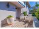 Bright and sunny front porch with white chairs and a large potted plant at 1688 Watermark Ne Cir, St Petersburg, FL 33702