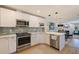 Open concept kitchen boasts stainless steel appliances and a large island at 1688 Watermark Ne Cir # 1688, St Petersburg, FL 33702