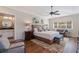 Main bedroom with hardwood floors, a ceiling fan, and en-suite bathroom at 1688 Watermark Ne Cir # 1688, St Petersburg, FL 33702