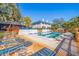 Community pool with lounge chairs and patio area at 1688 Watermark Ne Cir # 1688, St Petersburg, FL 33702
