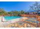 Inviting community pool with wooden deck, comfortable lounge chairs, and well-maintained surroundings at 1688 Watermark Ne Cir # 1688, St Petersburg, FL 33702