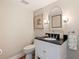 Modern powder room with black vanity and gold mirror at 1688 Watermark Ne Cir # 1688, St Petersburg, FL 33702
