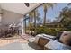 Relaxing screened porch with seating area and view of lush landscaping at 1688 Watermark Ne Cir # 1688, St Petersburg, FL 33702