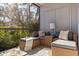 Cozy screened porch features wicker furniture and tranquil garden views at 1688 Watermark Ne Cir # 1688, St Petersburg, FL 33702