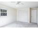 Empty bedroom with ceiling fan and closet at 1727 Belleair Forest Dr # B, Belleair, FL 33756