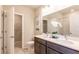 Double vanity bathroom with modern fixtures and large mirror at 174 Green Oak Park, Rotonda West, FL 33947