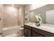 Bathroom with shower/tub combo and dark vanity at 174 Green Oak Park, Rotonda West, FL 33947