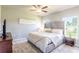 Spacious main bedroom with large window and neutral color palette at 174 Green Oak Park, Rotonda West, FL 33947