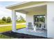 Covered patio with comfortable seating area at 174 Green Oak Park, Rotonda West, FL 33947