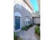 Exterior view of a house with gray siding, a blue door, and a walkway at 213 S Habana Ave, Tampa, FL 33609