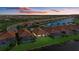 Aerial view of community with lake and homes at 23503 Waverly Cir, Venice, FL 34293