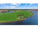 Aerial view of a golf course community with a lake at 23503 Waverly Cir, Venice, FL 34293