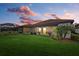 Backyard view at sunset with covered patio at 23503 Waverly Cir, Venice, FL 34293