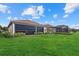 Spacious backyard with covered patio and lush lawn at 23503 Waverly Cir, Venice, FL 34293