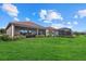 Spacious backyard with covered patio and lush lawn at 23503 Waverly Cir, Venice, FL 34293
