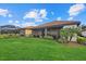 Large backyard with lush lawn and screened enclosure at 23503 Waverly Cir, Venice, FL 34293