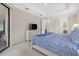 Primary bedroom with a king bed, TV, and access to patio at 23503 Waverly Cir, Venice, FL 34293