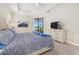 Bright bedroom with a king-size bed and access to balcony at 23503 Waverly Cir, Venice, FL 34293