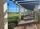 Brick pathway with pergola, offering scenic golf course views at 23503 Waverly Cir, Venice, FL 34293