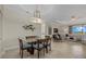 Elegant dining area with glass table, modern lighting, and open floor plan at 23503 Waverly Cir, Venice, FL 34293