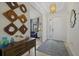 Bright and spacious entryway with wood-look floors and modern decor at 23503 Waverly Cir, Venice, FL 34293