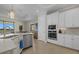 Bright kitchen featuring stainless steel appliances and white cabinetry at 23503 Waverly Cir, Venice, FL 34293