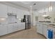 Modern kitchen featuring stainless steel appliances and white cabinetry at 23503 Waverly Cir, Venice, FL 34293