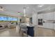 Modern kitchen with white cabinets, stainless steel appliances, and a large island at 23503 Waverly Cir, Venice, FL 34293